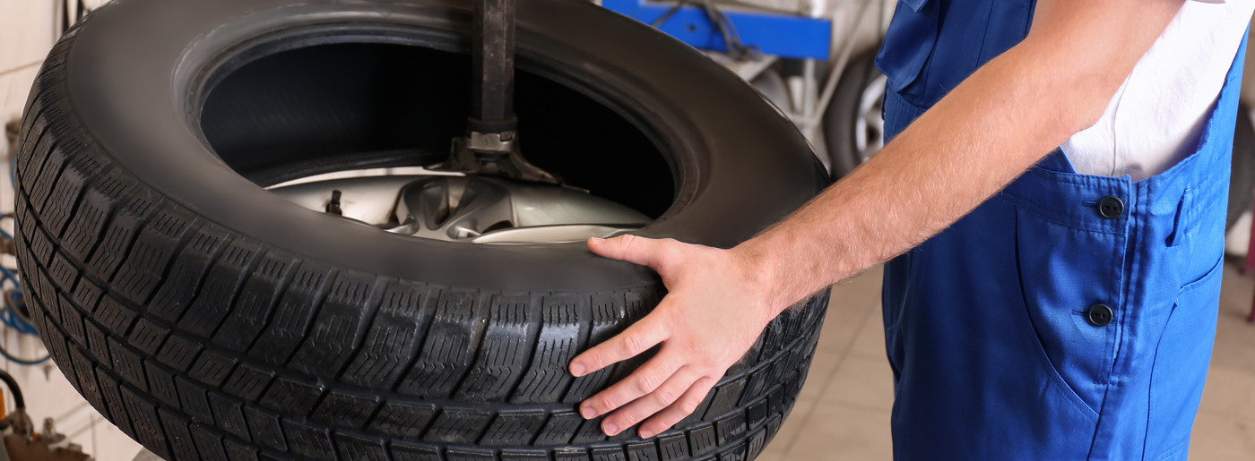 Mechanic holding a tyre - Tyres Bathgate